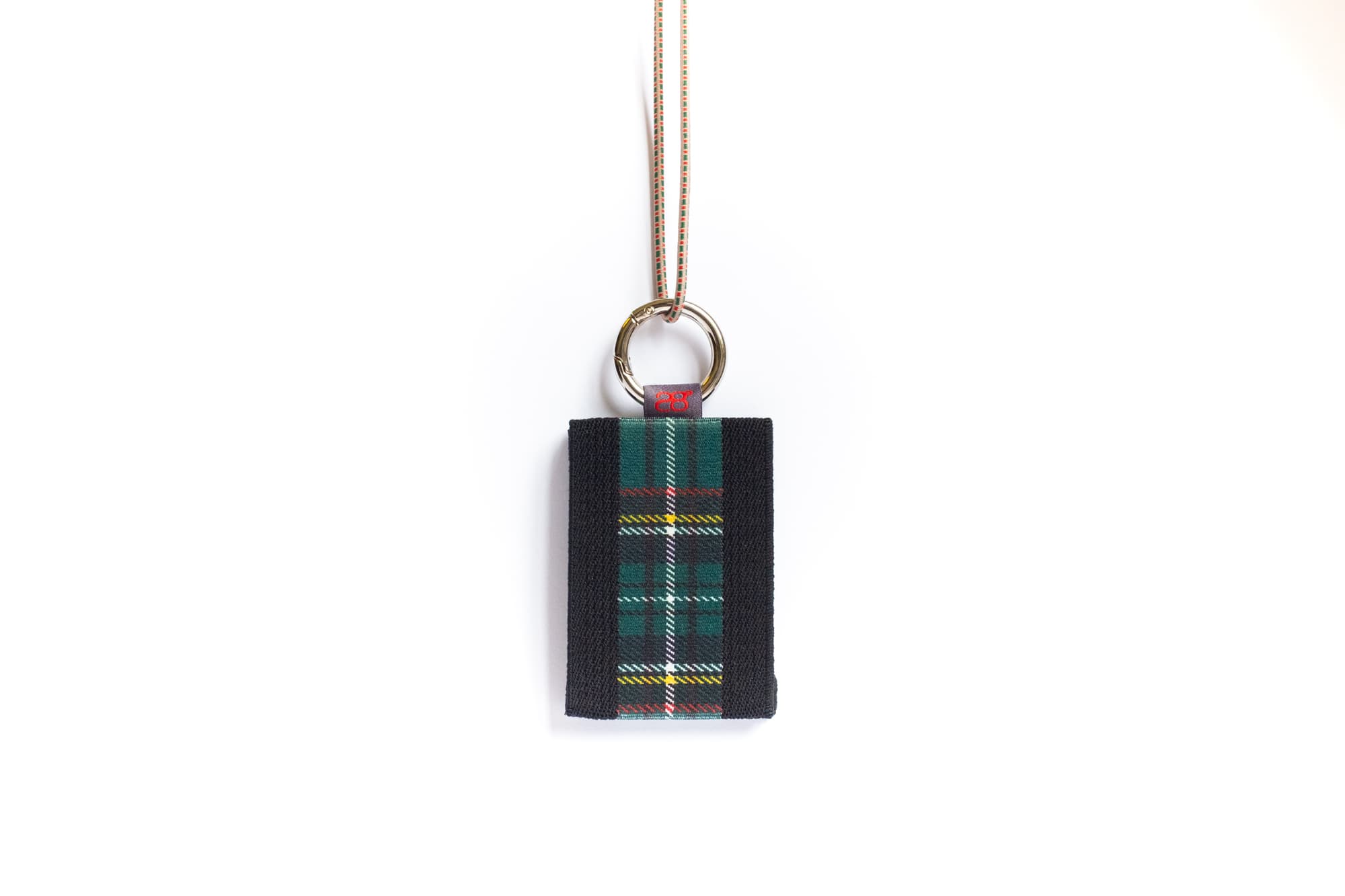 Nº8 portemonnee in zwart met tartan-band, hangend aan een koord
